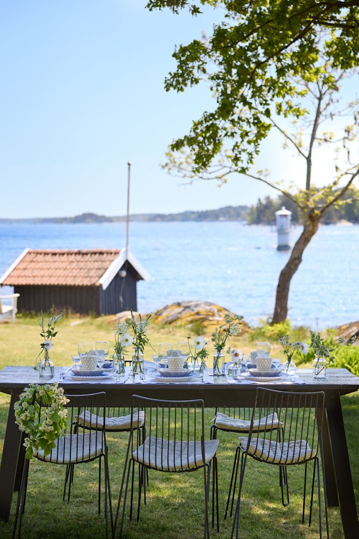 Et dækket bord med en beige oyster skål i farven sand og en grå skål, tallerken og krus fra serierne Basica, MSY, Strips og Oyster fra Mateus.