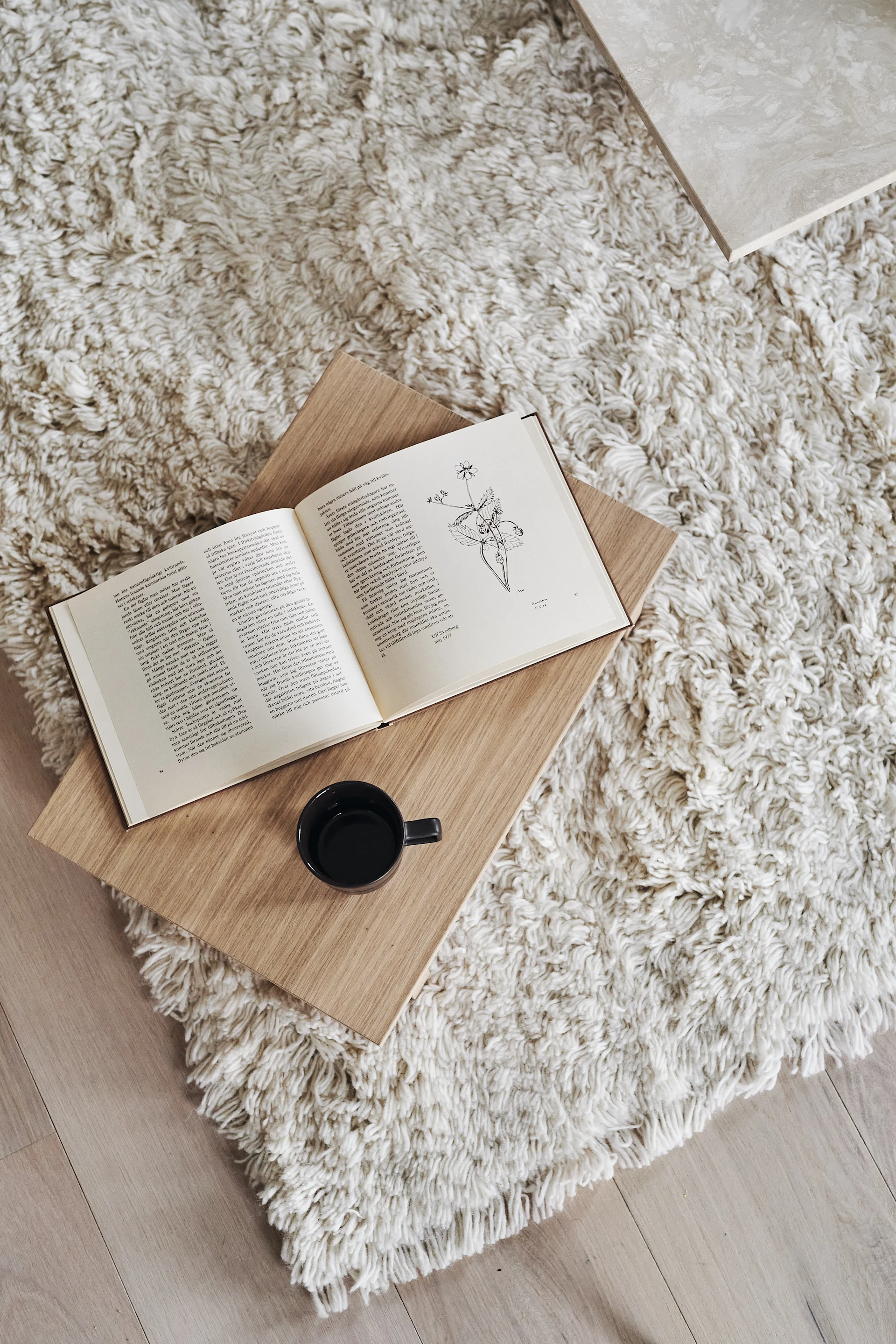 Skab hotelfornemmelser i soveværelset ved hjælp af et blødt uldtæppe, som dette hvide tæppe med lange hår fra Scandi Living.