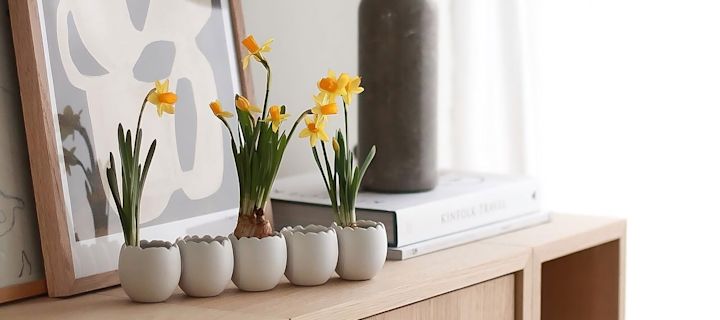 To kuglevaser i forskellige former og størrelser fra Cooee Design med forårsblomster står på en bakke ved siden af flere trillinger af påskeharer fra DBKD i @sachi_rooooms hjem.